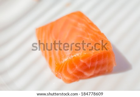 Three pieces of salmon on cutting board