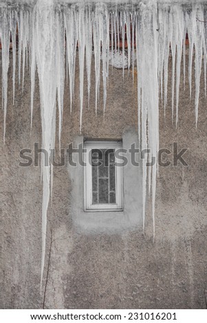 Long Icicles Hanging from Roof down to Wall
