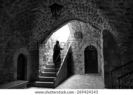 Nun walks up the stairs in the monastery