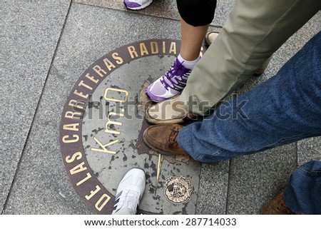 MADRID, SPAIN - OCTOBER 03, 2013: Legs of tourists on the mark \