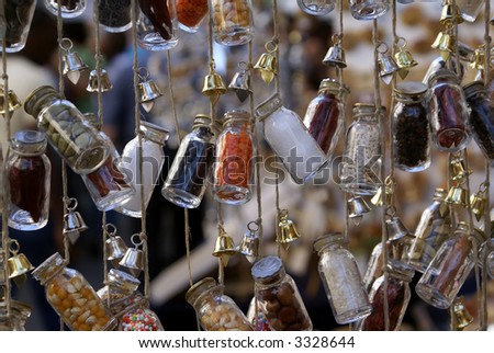 The small bottles filled by groats and spices, suspended on a cord
