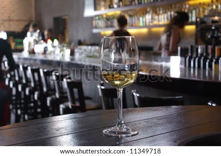Lonely wine glass on a background of a bar