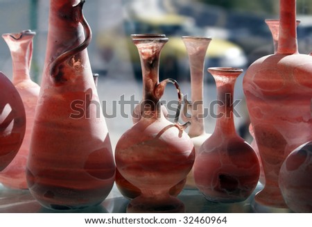 Glass vessels of the different form stand in a shop show-window
