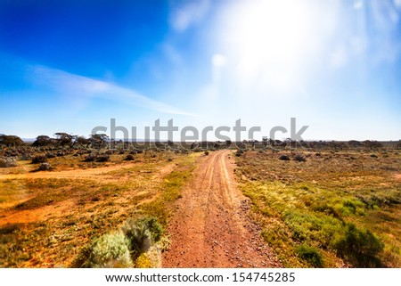 Small Gravel Road In Australian Outback In Bright Sunshine