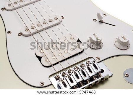 Close up of the pickups and bridge of a white electric guitar. Isolated on White.