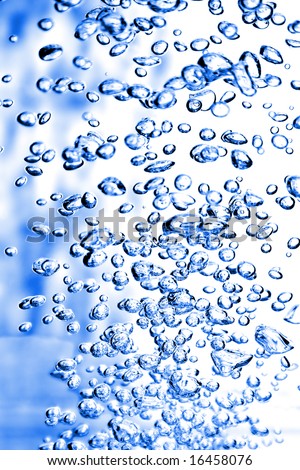 Blue air bubbles in water, vertically orientated frame. Not all bubbles fall on the focal plane.