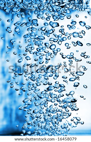 Blue Air Bubbles in water casting shadows on the background. Not all bubbles fall on the focal plane.