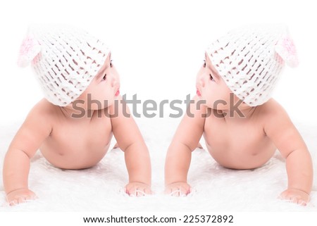 asian cute boy five month wearing a white crochet hat on white background