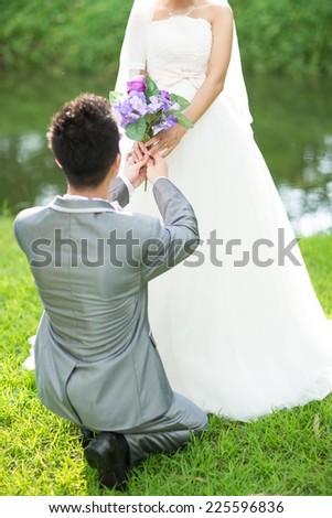 guy on knees proposing girl. Will you marry me?