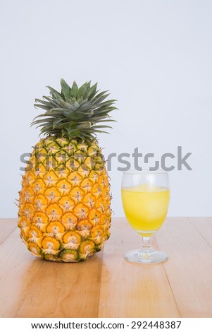 Fresh  pineapple and pineapple juice on wood table