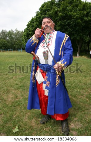 Old ukrainian Cossack with long whiskers smoking pipe