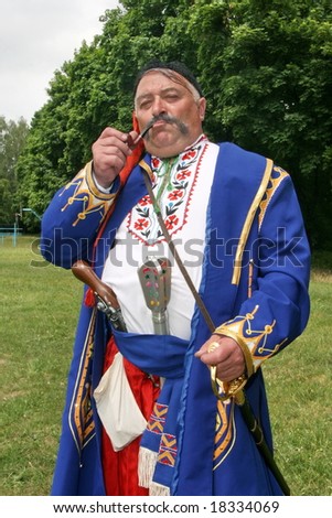 Old ukrainian Cossack with long whiskers smoking pipe