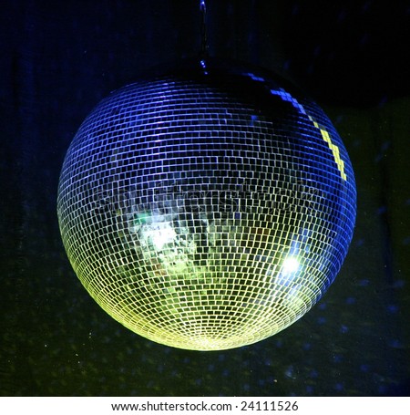 night club lighting yellow mirror-ball over black