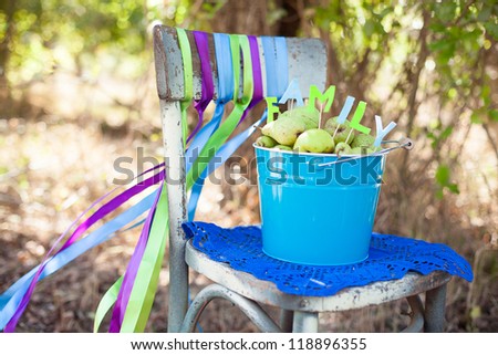 Nice arrangement of bucket and pears in it that says \