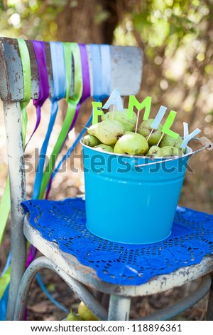 Nice arrangement of bucket and pears in it that says \