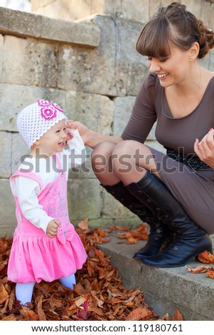 Family portrait cute little girl and happy mother. Autumn in the park. A series of photos in my portfolio