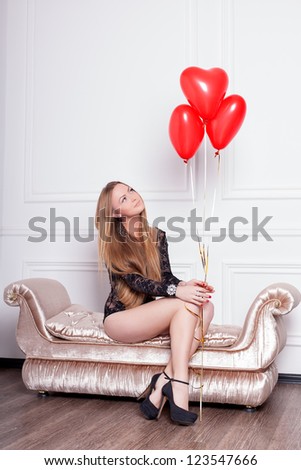 Young and sexy woman  holding balloons in the form of heart wearing black lingerie, series