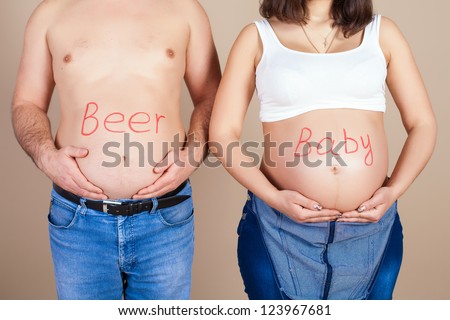 belly of pregnant wife and husband. Humorous inscription \