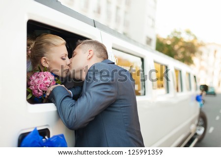 couple in love bride and groom posing at car window