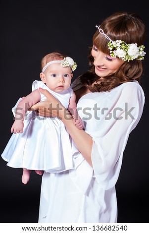 mother holds infant daughter in her arms