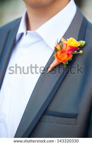 Wonderful wedding boutonniere on a costume of groom