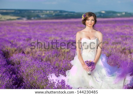 Beautiful bride posing at field of lavender