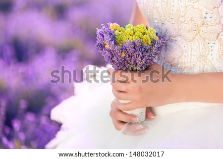 woman hands in fairy field of lavender with bouquet