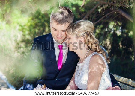 Beautiful wedding couple hugging. Bride and groom celebrating their wedding day in summer