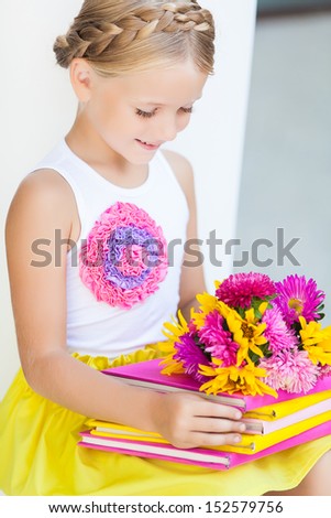 Education - funny girl with a books and flowers