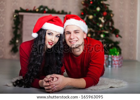 Christmas Couple.Happy Smiling Family at home celebrating. New year/