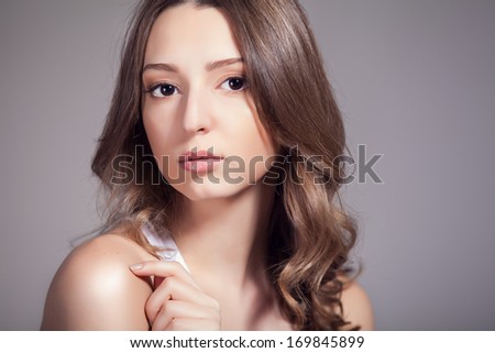 Portrait of a sensual woman. Natural beauty of a young woman in the studio. Head and shoulders portrait of a beautiful young woman