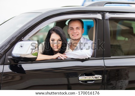 Young couple on road trip in new car. Happy couple.