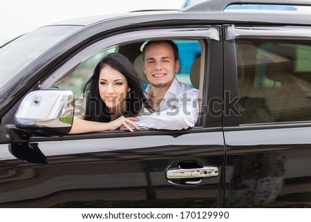 Young couple on road trip in new car. Happy couple.