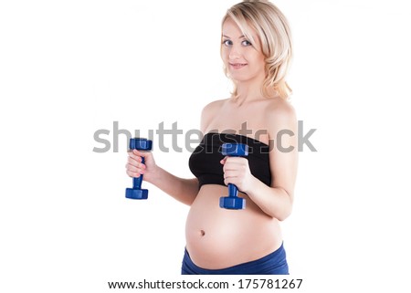 A pregnant woman exercising with a light weights - isolated. Workout indoors, sport for expectant female, healthy pregnancy concept
