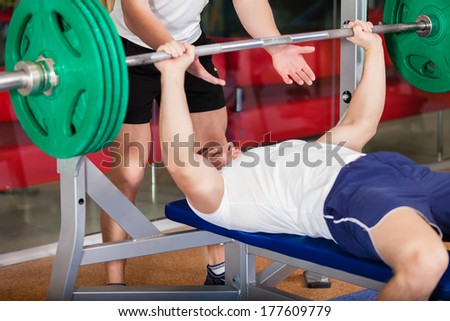 Two muscular young man working out in the gym