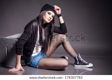 young girl with unique fashion sense looking away