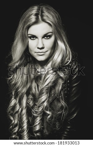 portrait of a beautiful blonde girl in the studio with magnificent hair. Black and white