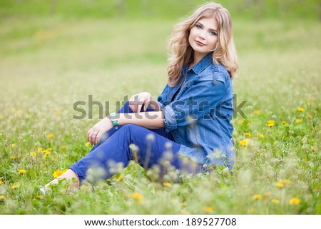 Beautiful young woman enjoying summer holiday on flower field