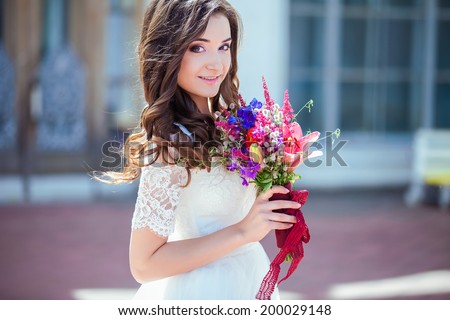 Happy, in love, beautiful bride with wedding bouquet flowers