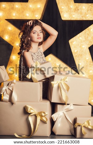 Fashion woman with lots of gifts. Brodway star on background