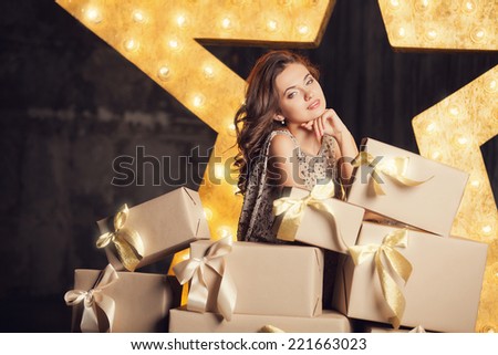 Fashion woman with lots of gifts. Brodway star on background