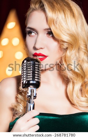 Beautiful Singing Girl. Beauty Woman with Microphone