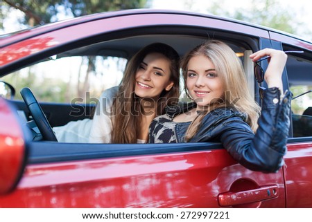 Girls in the red car. Little holiday trip of friends