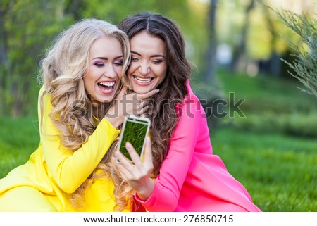 Female best friends on the green grass