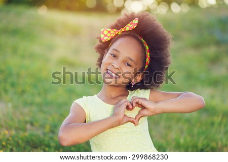 Outdoor portrait of pretty mixed race African-American girl smiling outdoor