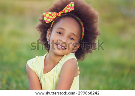 Outdoor portrait of pretty mixed race African-American girl smiling outdoor