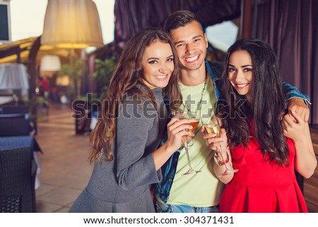 Friends at party drinking cocktails and having fun - Three tourists drinking aperitif in a restaurant