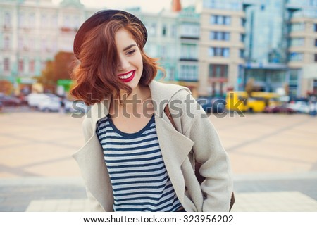 young stylish pretty woman with hat posing in the city streets. vacation europe