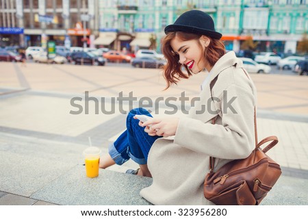 young stylish pretty woman with juice posing in the city streets. vacation europe