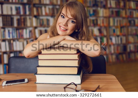 Portrait of a young female student standing in university library